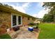 Backyard featuring a brick house, a patio area, and a well-maintained lawn at 1472 High Meadow Dr, Stone Mountain, GA 30083