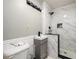 Modern bathroom with a sleek vanity, updated fixtures, and a tiled shower with marble-style wall panels at 1472 High Meadow Dr, Stone Mountain, GA 30083