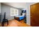 Bedroom with wood flooring, a cozy bed, and a window with natural light at 1472 High Meadow Dr, Stone Mountain, GA 30083