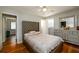 Bedroom featuring a bed, dresser, and hardwood floors at 1472 High Meadow Dr, Stone Mountain, GA 30083