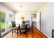 Dining area with a glass table, gray chairs, and natural light from the door at 1472 High Meadow Dr, Stone Mountain, GA 30083