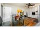 Cozy dining area features an elegant glass table and modern ceiling fan at 1472 High Meadow Dr, Stone Mountain, GA 30083