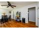 Bright dining space boasting dark wood floors, a ceiling fan, and an adjacent room entrance at 1472 High Meadow Dr, Stone Mountain, GA 30083