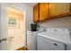Laundry area with a white washer and dryer near bathroom at 1472 High Meadow Dr, Stone Mountain, GA 30083