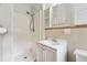Compact bathroom featuring a shower stall, vanity, and a mirrored cabinet for convenient storage at 1913 Ferry Dr, Marietta, GA 30066