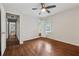 Spacious bedroom with gleaming hardwood floors, a ceiling fan, and access to an ensuite bathroom at 1913 Ferry Dr, Marietta, GA 30066