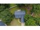 Aerial view of a home with a dark roof, mature trees, and a well-maintained lawn at 556 Walton Dr, Social Circle, GA 30025