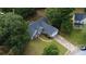 Aerial view of a home with a gray exterior, a long driveway, and a well-kept lawn at 556 Walton Dr, Social Circle, GA 30025
