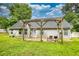 Enjoy outdoor living with this backyard featuring a wooden pergola and grassy area at 556 Walton Dr, Social Circle, GA 30025