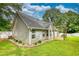 Beautiful backyard with lush green grass, trees, and a cozy pergola at 556 Walton Dr, Social Circle, GA 30025