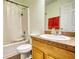 Bathroom featuring a shower with white curtain, a toilet and a sink with wooden cabinets at 556 Walton Dr, Social Circle, GA 30025