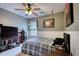 Cozy bedroom featuring carpeted floors, ceiling fan, and closet at 556 Walton Dr, Social Circle, GA 30025