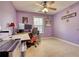Bedroom with purple walls, ceiling fan, and large window at 556 Walton Dr, Social Circle, GA 30025