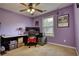 Bright bedroom featuring a ceiling fan, large window, and carpeted floors at 556 Walton Dr, Social Circle, GA 30025