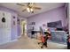 Bedroom featuring a desk and a ceiling fan and an open door at 556 Walton Dr, Social Circle, GA 30025