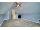 Bonus room showcasing neutral carpet, sloped ceilings, a ceiling fan, and plenty of space at 556 Walton Dr, Social Circle, GA 30025