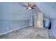 Bonus room features soft carpet, sloped ceilings, and a doorway to another space at 556 Walton Dr, Social Circle, GA 30025