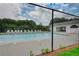 Fenced community pool area with lounge chairs surrounding the clear blue pool and a pool house nearby at 556 Walton Dr, Social Circle, GA 30025