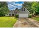 Charming single-Gathering home with a well-maintained lawn and attached two-car garage at 556 Walton Dr, Social Circle, GA 30025