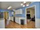 Well-designed kitchen featuring white cabinetry, modern appliances and seamless access to living room at 556 Walton Dr, Social Circle, GA 30025