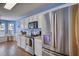 Modern kitchen featuring stainless steel appliances and white cabinets with view to breakfast nook at 556 Walton Dr, Social Circle, GA 30025