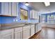Well-lit kitchen with white cabinets, modern appliances, and seamless flow to the breakfast area at 556 Walton Dr, Social Circle, GA 30025