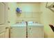 Practical laundry room featuring a washer, dryer, and wire shelving for storage at 556 Walton Dr, Social Circle, GA 30025