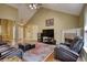 Living room with a fireplace, vaulted ceilings, wood floors, and cozy seating area at 556 Walton Dr, Social Circle, GA 30025