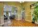 Comfortable living room with wood floors, a black sofa, and seamless transition into other spaces at 556 Walton Dr, Social Circle, GA 30025