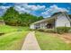 Community pool house with picnic tables on a grassy area and a paved walkway at 556 Walton Dr, Social Circle, GA 30025