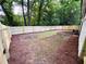 New backyard wooden fence and a large yard with pine straw accents ready for landscaping at 1703 Barrett Nw Dr, Atlanta, GA 30318