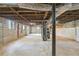 Spacious unfinished basement featuring exposed plumbing and concrete flooring, offering potential for customization at 1703 Barrett Nw Dr, Atlanta, GA 30318