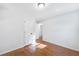 Simple bedroom with hardwood floors and neutral paint; adjacent to bath at 1703 Barrett Nw Dr, Atlanta, GA 30318