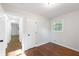 Cozy bedroom with fresh white paint, hardwood floors, a window, and a white door at 1703 Barrett Nw Dr, Atlanta, GA 30318