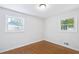 Bedroom with hardwood floors, neutral walls, base trim, and double windows at 1703 Barrett Nw Dr, Atlanta, GA 30318