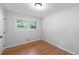 Cozy bedroom with a window bringing in natural light and hardwood floors at 1703 Barrett Nw Dr, Atlanta, GA 30318