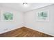 Bright bedroom with hardwood floors, neutral walls, base trim, and double windows at 1703 Barrett Nw Dr, Atlanta, GA 30318