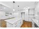 Open-concept kitchen featuring shaker cabinets, stainless appliances, and a granite island at 1703 Barrett Nw Dr, Atlanta, GA 30318