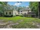 Sprawling backyard with lush lawn, mature trees, screened porch, and deck, ideal for outdoor enjoyment at 2110 Waterloo Cir, Lawrenceville, GA 30043