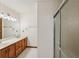Bathroom featuring a double vanity with wood cabinetry and a glass-enclosed shower at 2110 Waterloo Cir, Lawrenceville, GA 30043