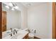 The powder room features a wood vanity, large mirror, and neutral walls at 2110 Waterloo Cir, Lawrenceville, GA 30043