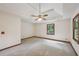 A spacious primary bedroom has plush carpet, tray ceiling, fan, and natural light at 2110 Waterloo Cir, Lawrenceville, GA 30043