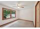 Bedroom features neutral carpet, a ceiling fan, and a window with backyard views at 2110 Waterloo Cir, Lawrenceville, GA 30043