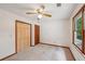 Bedroom features a ceiling fan, closet, and a large window letting in natural light at 2110 Waterloo Cir, Lawrenceville, GA 30043