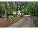 A charming two-story home surrounded by mature trees and a long driveway at 2110 Waterloo Cir, Lawrenceville, GA 30043