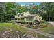 A charming two-story home featuring a long driveway surrounded by lush greenery and trees at 2110 Waterloo Cir, Lawrenceville, GA 30043