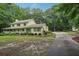 A charming two-story home featuring a long driveway surrounded by lush greenery and trees at 2110 Waterloo Cir, Lawrenceville, GA 30043