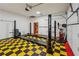 Spacious garage featuring a Dannmar car lift and checkerboard flooring, perfect for car enthusiasts at 2110 Waterloo Cir, Lawrenceville, GA 30043