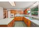 The eat-in kitchen has honey oak cabinets, lots of counter space, and stainless dishwasher at 2110 Waterloo Cir, Lawrenceville, GA 30043
