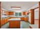 A bright eat-in kitchen features honey oak cabinets, an island, and a garden view at 2110 Waterloo Cir, Lawrenceville, GA 30043
